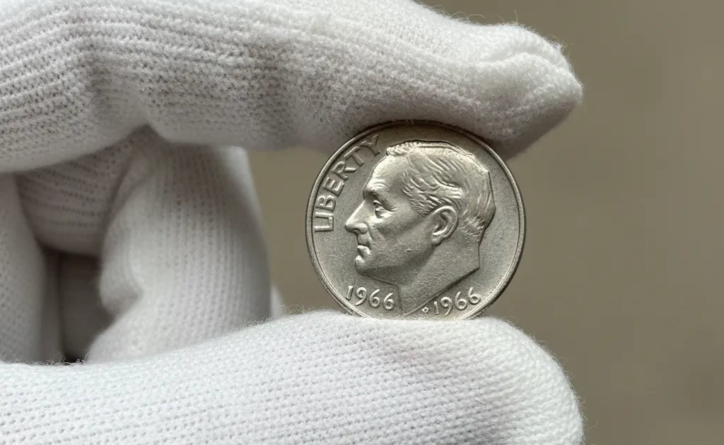 1966 Dime in the white gloved hand